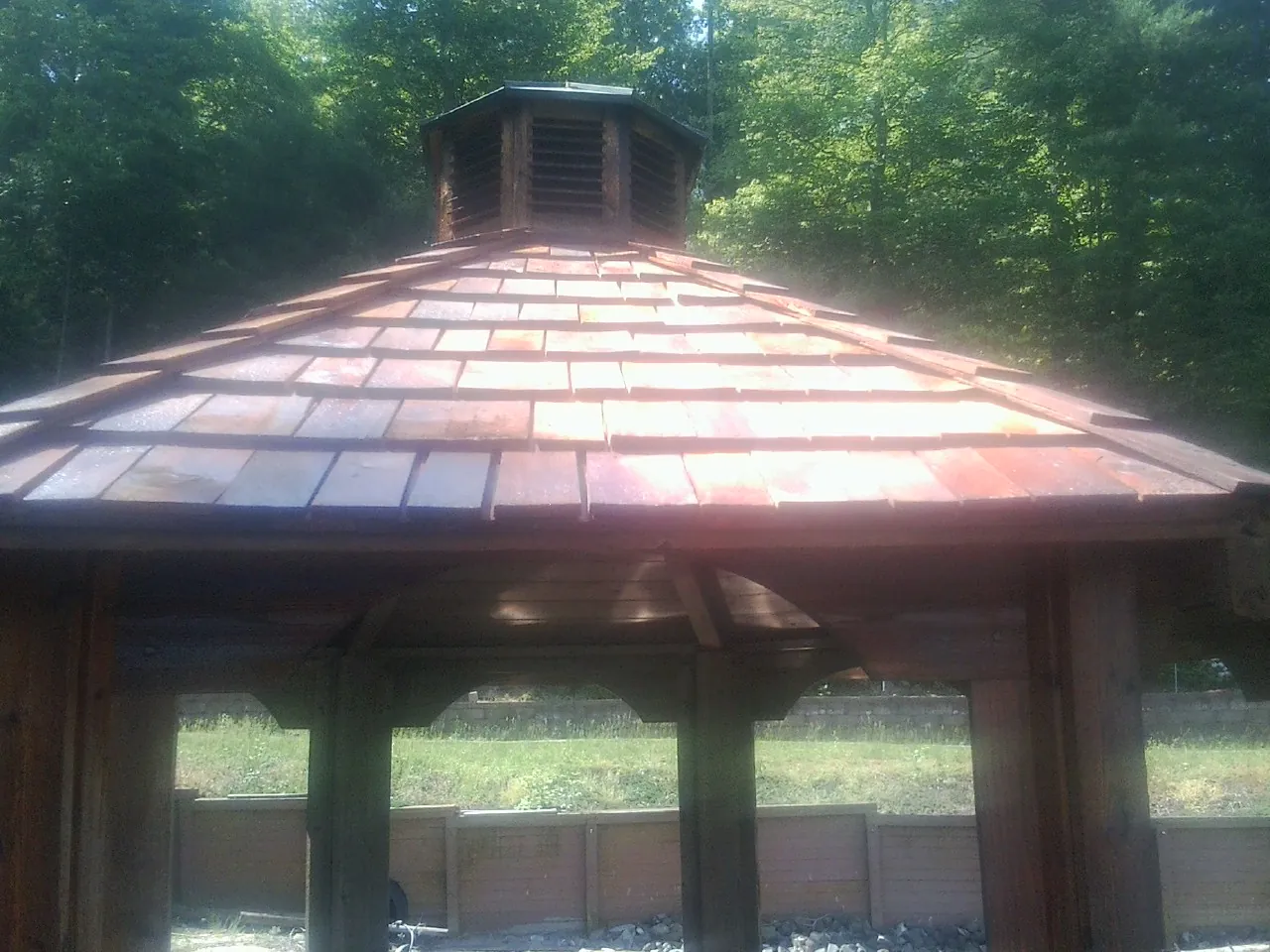 New cedar shake roof and cupola on a lakeside gazebo in Chichester