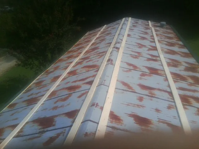 Rusted metal roof panels with new wood purlins before replacement — Storm Damage Roof Repair in Chichester by Roofing Brothers